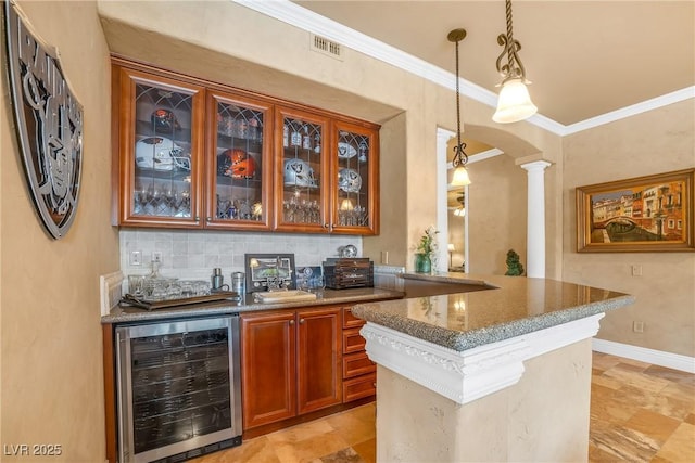 20 Via Mantova Unit 306, Henderson, NV 89011 - indoor bar featuring wine cooler, decorative columns, arched walkways, decorative light fixtures, and ornamental molding