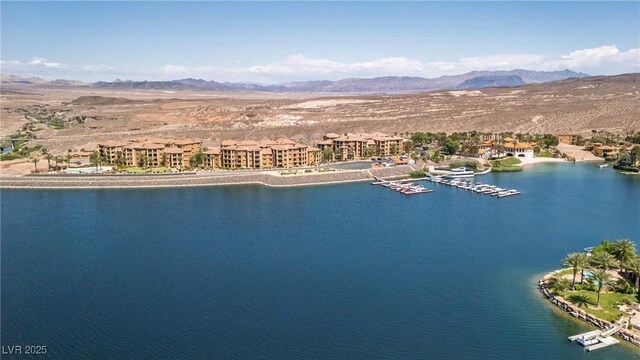 drone / aerial view with a water and mountain view