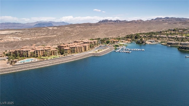 aerial view featuring a water and mountain view