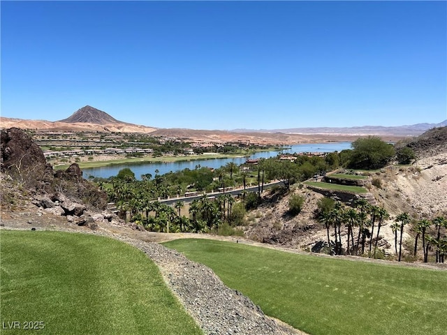 view of property's community with a lawn and a water and mountain view