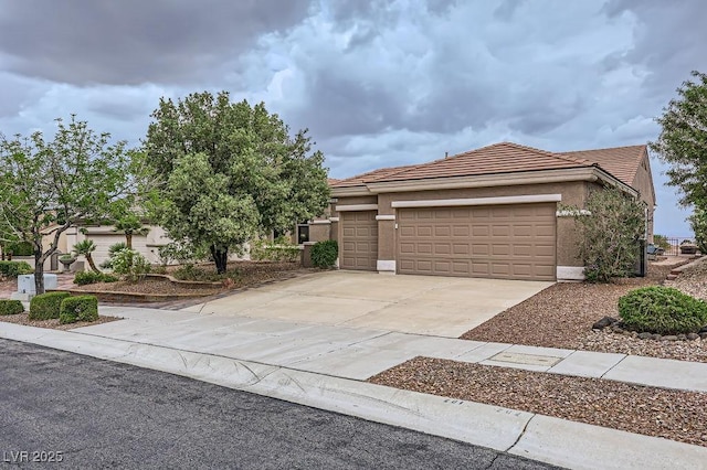 2110 King Mesa Dr, Henderson, NV 89012 - view of front facade featuring a tile roof, concrete driveway, an attached garage, and stucco siding