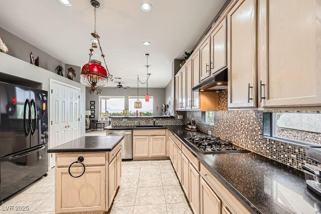 2110 King Mesa Dr, Henderson, NV 89012 - kitchen with appliances with stainless steel finishes, under cabinet range hood, light brown cabinets, backsplash, and a peninsula