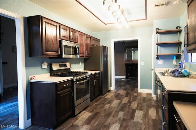 9000 Litchfield Ave, Las Vegas, NV 89134 - kitchen with visible vents, baseboards, light countertops, dark wood finished floors, and stainless steel appliances