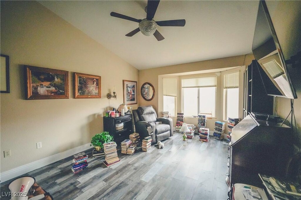 9000 Litchfield Ave, Las Vegas, NV 89134 - sitting room featuring vaulted ceiling, baseboards, a ceiling fan, and wood finished floors