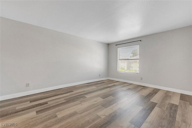 2451 N Rainbow Blvd Unit 2144, Las Vegas, NV 89108 - unfurnished room featuring wood finished floors and baseboards
