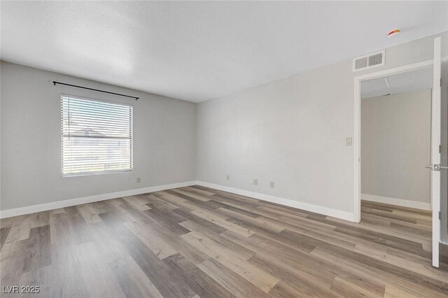 2451 N Rainbow Blvd Unit 2144, Las Vegas, NV 89108 - spare room with wood finished floors and baseboards