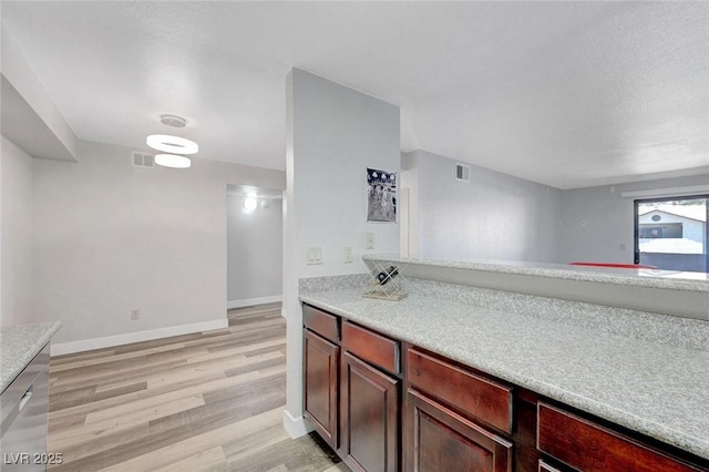 2451 N Rainbow Blvd Unit 2144, Las Vegas, NV 89108 - kitchen with light countertops, light wood-type flooring, baseboards, and dark brown cabinets