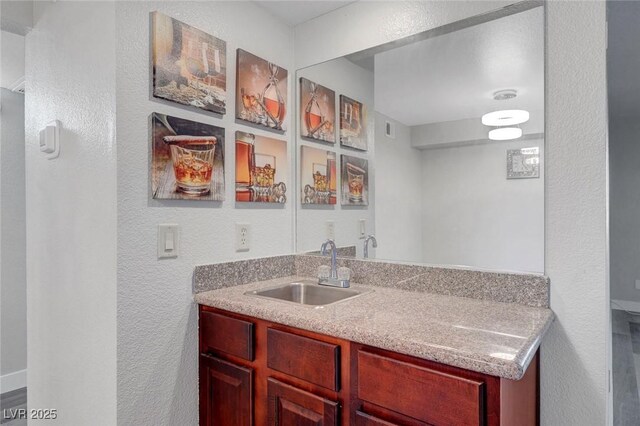 2451 N Rainbow Blvd Unit 2144, Las Vegas, NV 89108 - bar area featuring a sink and a textured wall