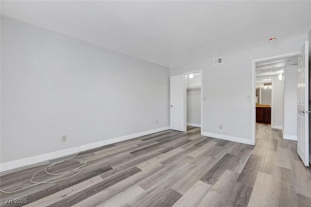 2451 N Rainbow Blvd Unit 2144, Las Vegas, NV 89108 - unfurnished bedroom with wood finished floors and baseboards