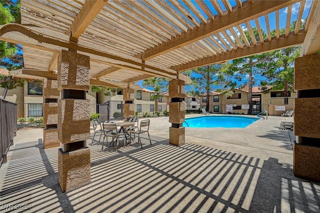 pool with a patio area, fence, and a pergola