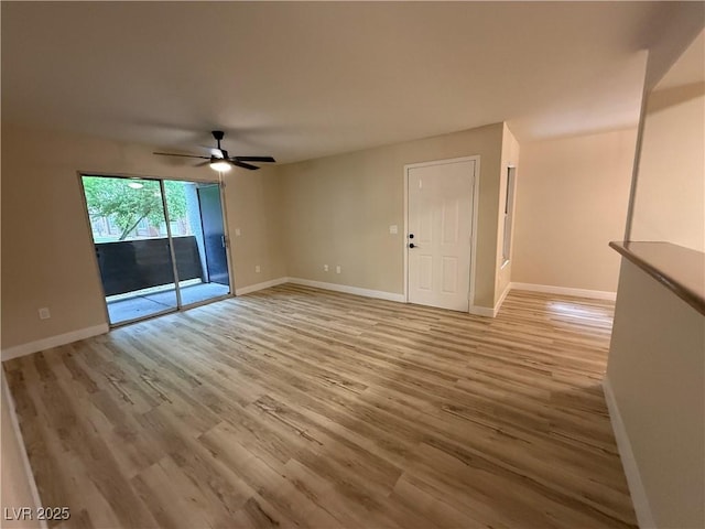 spare room featuring baseboards, ceiling fan, and light wood-style floors