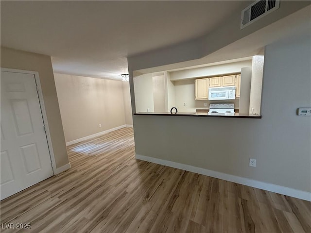 interior space featuring visible vents, baseboards, and light wood-style floors