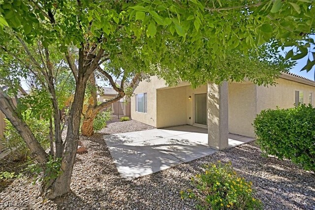 6001 Falconer Ave, Las Vegas, NV 89122 - back of property featuring stucco siding, a patio area, and fence