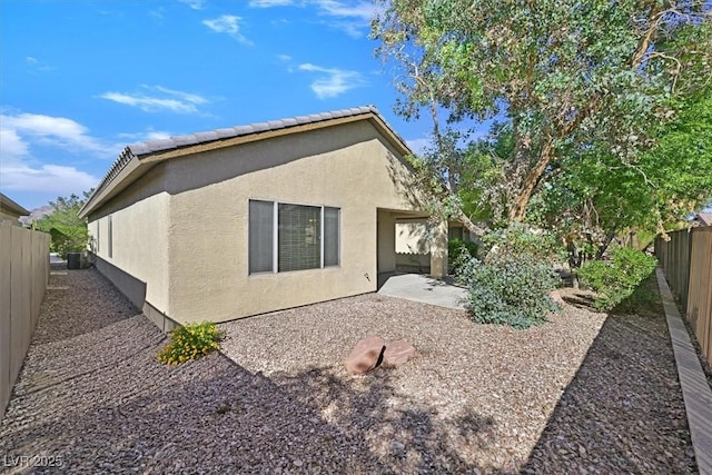 6001 Falconer Ave, Las Vegas, NV 89122 - back of property with stucco siding, a fenced backyard, and a patio area