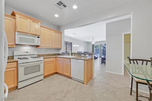 6001 Falconer Ave, Las Vegas, NV 89122 - kitchen featuring white appliances, light brown cabinets, a peninsula, a chandelier, and a sink