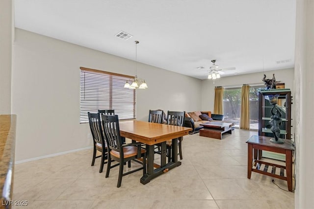 6001 Falconer Ave, Las Vegas, NV 89122 - dining space featuring a chandelier, a ceiling fan, light tile patterned floors, and baseboards