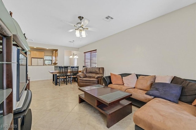 6001 Falconer Ave, Las Vegas, NV 89122 - living room with light tile patterned floors, a chandelier, and ceiling fan
