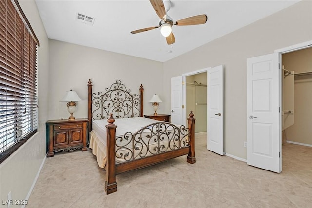 6001 Falconer Ave, Las Vegas, NV 89122 - bedroom featuring a spacious closet, baseboards, a ceiling fan, and a closet