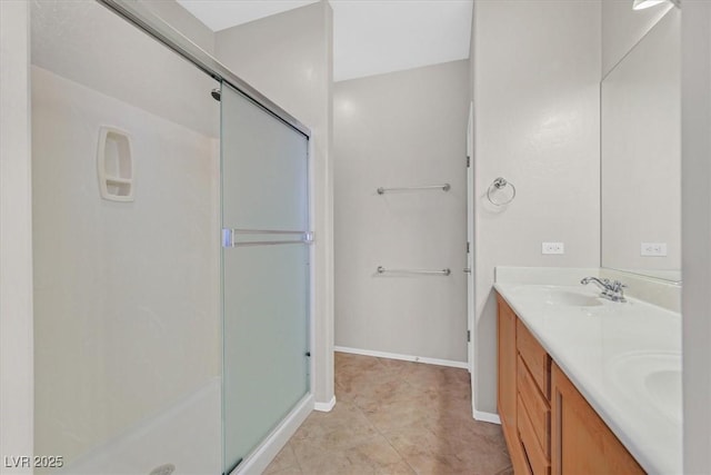 6001 Falconer Ave, Las Vegas, NV 89122 - bathroom featuring a shower stall, double vanity, and baseboards