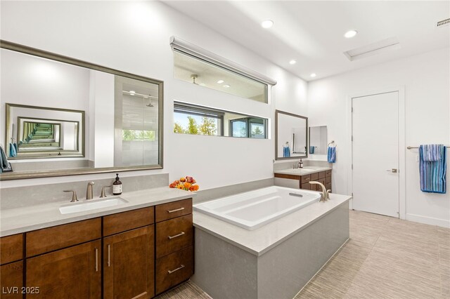 15 Gemstar Ln, Las Vegas, NV 89135 - full bath with a sink, two vanities, a garden tub, and recessed lighting
