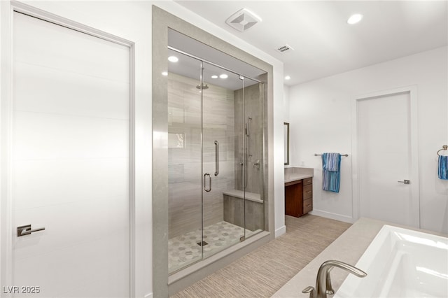15 Gemstar Ln, Las Vegas, NV 89135 - bathroom with vanity, a shower stall, recessed lighting, and a garden tub