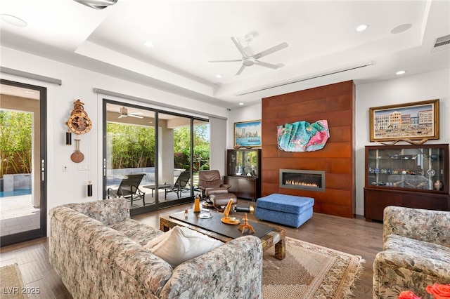 15 Gemstar Ln, Las Vegas, NV 89135 - living room featuring a tray ceiling, wood finished floors, a ceiling fan, and recessed lighting