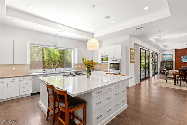 15 Gemstar Ln, Las Vegas, NV 89135 - kitchen with decorative backsplash, visible vents, appliances with stainless steel finishes, a tray ceiling, and recessed lighting