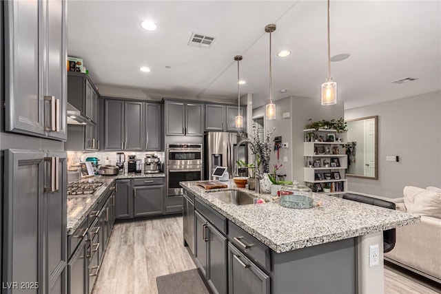 39 Castleton Tower Ct, Henderson, NV 89011 - kitchen featuring visible vents, gray cabinets, light wood finished floors, and stainless steel appliances