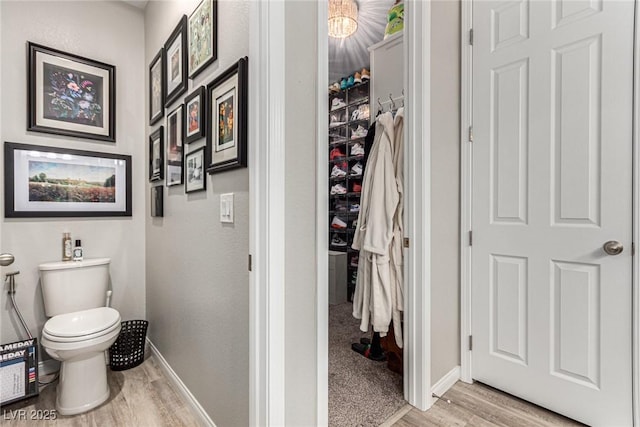 39 Castleton Tower Ct, Henderson, NV 89011 - bathroom with baseboards, wood finished floors, and toilet