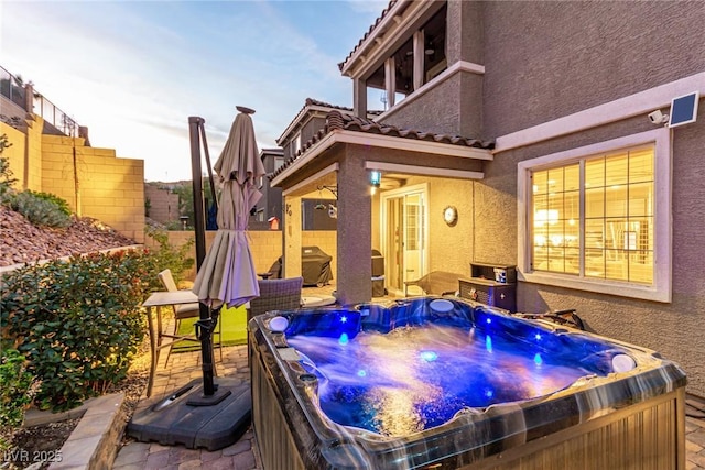 39 Castleton Tower Ct, Henderson, NV 89011 - view of patio / terrace with a hot tub and fence