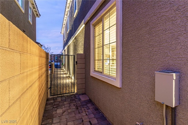 39 Castleton Tower Ct, Henderson, NV 89011 - view of home's exterior featuring a gate, stucco siding, and fence