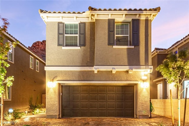 39 Castleton Tower Ct, Henderson, NV 89011 - view of front of property with a garage, fence, stucco siding, and decorative driveway