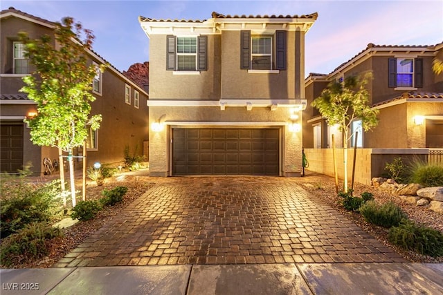 39 Castleton Tower Ct, Henderson, NV 89011 - mediterranean / spanish-style house with a tiled roof, stucco siding, an attached garage, and decorative driveway