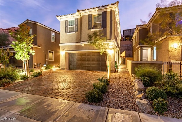 39 Castleton Tower Ct, Henderson, NV 89011 - mediterranean / spanish home with an attached garage, decorative driveway, stucco siding, and fence