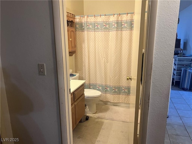 full bathroom with vanity, toilet, curtained shower, and tile patterned floors
