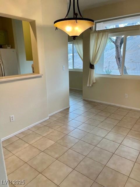 3349 Partridge Run St, Laughlin, NV 89029 - unfurnished dining area featuring light tile patterned floors and baseboards