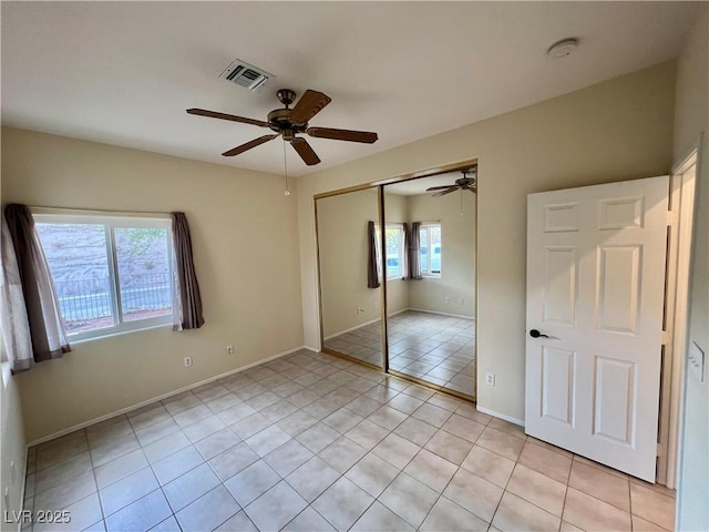 3349 Partridge Run St, Laughlin, NV 89029 - unfurnished bedroom with light tile patterned flooring, a closet, ceiling fan, and baseboards
