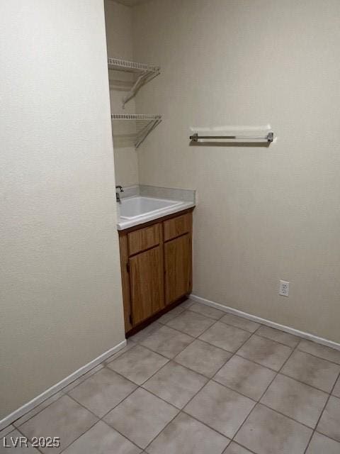 3349 Partridge Run St, Laughlin, NV 89029 - laundry area with a sink, light tile patterned floors, and baseboards