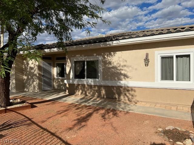 3349 Partridge Run St, Laughlin, NV 89029 - view of side of home with a patio and stucco siding