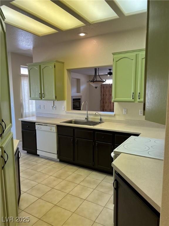 3349 Partridge Run St, Laughlin, NV 89029 - kitchen with white dishwasher, a sink, light countertops, range, and light tile patterned floors