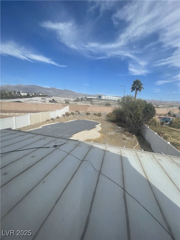 view of pool with a patio, fence, and a mountain view