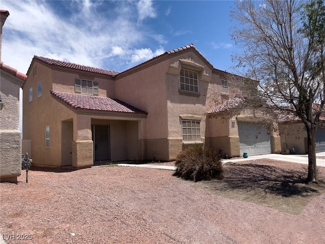 6726 Montezuma Castle Ln, North Las Vegas, NV 89084 - mediterranean / spanish house featuring a tiled roof, stucco siding, and a garage