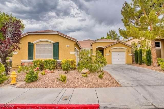 2383 Rainswept Ave, Henderson, NV 89052 - view of front of home with an attached garage, driveway, and stucco siding