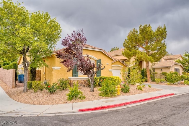 2383 Rainswept Ave, Henderson, NV 89052 - view of front of property featuring a garage, fence, and stucco siding