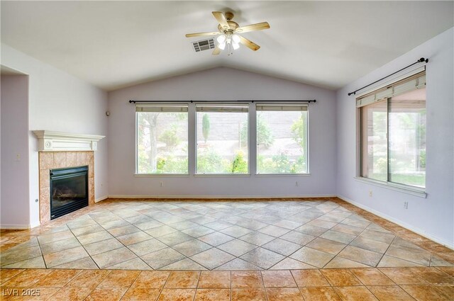 2383 Rainswept Ave, Henderson, NV 89052 - unfurnished living room with ceiling fan, visible vents, a tiled fireplace, baseboards, and lofted ceiling