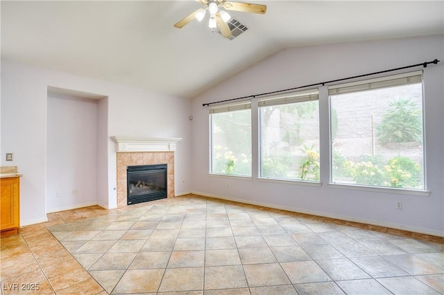 2383 Rainswept Ave, Henderson, NV 89052 - unfurnished living room with ceiling fan, visible vents, a tiled fireplace, light tile patterned floors, and vaulted ceiling