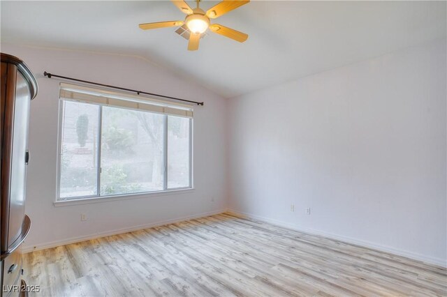 2383 Rainswept Ave, Henderson, NV 89052 - empty room with light wood-style floors, a ceiling fan, a wealth of natural light, and vaulted ceiling