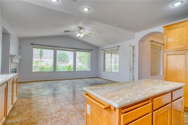 2383 Rainswept Ave, Henderson, NV 89052 - kitchen with arched walkways, a ceiling fan, open floor plan, lofted ceiling, and visible vents