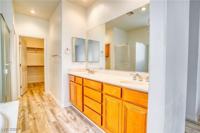 2383 Rainswept Ave, Henderson, NV 89052 - full bath featuring visible vents, a sink, wood finished floors, and a shower stall