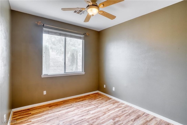 2383 Rainswept Ave, Henderson, NV 89052 - unfurnished room with baseboards, a ceiling fan, wood finished floors, and visible vents